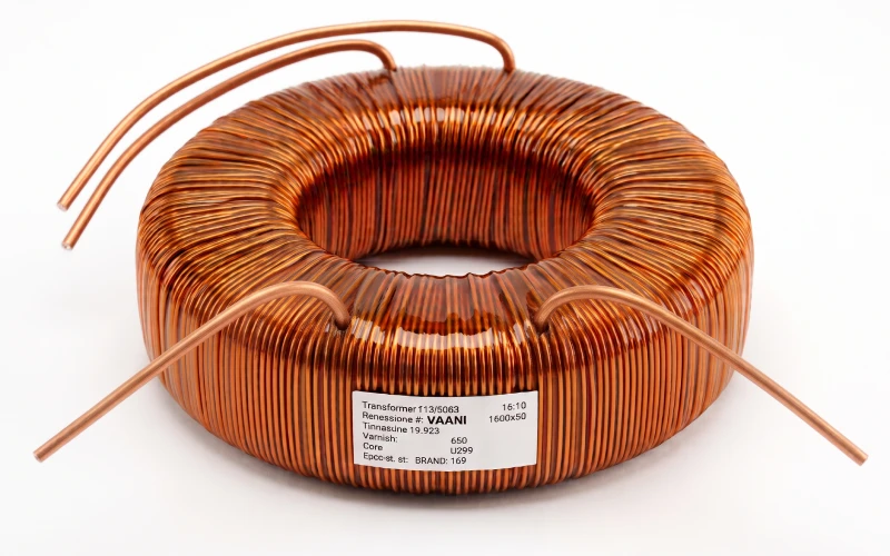 Vacuum-impregnated toroidal transformer with windings sealed solid against moisture, hum, and heat